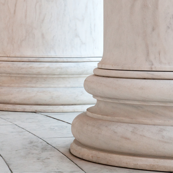 A line of white marble columns in a building